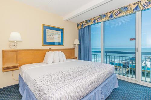 a bedroom with a bed and a large window at Yachtsman S406 2 BR in Myrtle Beach