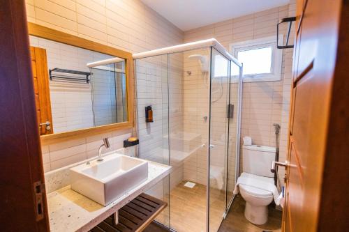 a bathroom with a sink and a toilet and a shower at Landruá Flat in São Luís