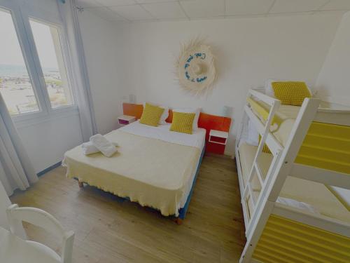 a bedroom with two bunk beds and a ladder at Hotel Camille in Saintes-Maries-de-la-Mer
