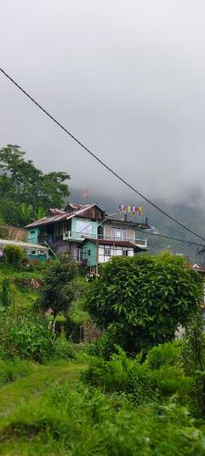 a house sitting on top of a hill at Saamiyanaa Cloud Nest in Kalimpong