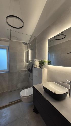 a bathroom with a sink and a toilet at Rimac Apartments in Novalja