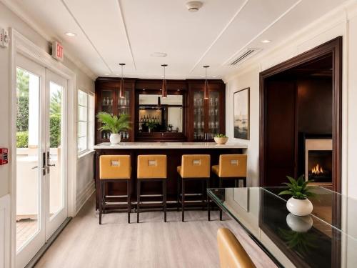 a kitchen with a bar with chairs and a fireplace at Monaco Bay Club 13 in Fort Lauderdale