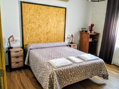 a bedroom with a bed with two towels on it at Hostal La Mancha in Ruidera