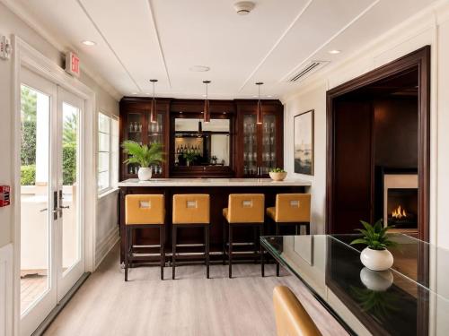 a kitchen with a bar with chairs and a fireplace at Monaco Bay Club 3 in Fort Lauderdale
