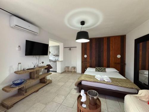 a bedroom with a bed and a flat screen tv at Apartment Simone in Lecce