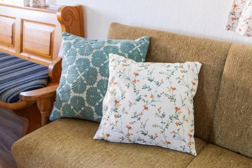 a pillow sitting on a couch next to a chair at Winzerhaus Löscherannerl in Kogl