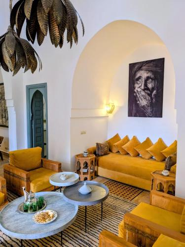 a living room with a couch and tables at Villa Marrakech Beldi in Najem