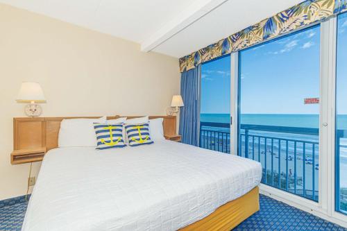 a bedroom with a bed and a view of the ocean at Oceanfront 1BR by Skywheel Yachtsman 701 in Myrtle Beach
