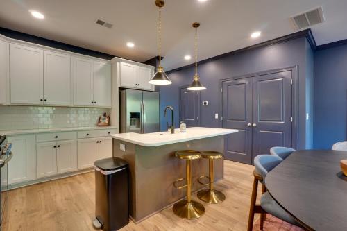 a kitchen with white cabinets and a blue wall at Dock Access! 'Hook & Heron Lakefront Getaway' in Greenwood