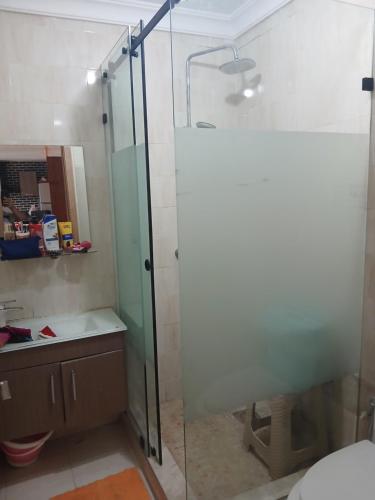 a shower with a glass door in a bathroom at Puerto banus beach Apt Famillies and married couples in Mansouria