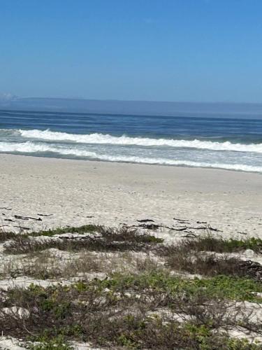a sandy beach with the ocean in the background at Duneberry Beach Studio in Yzerfontein
