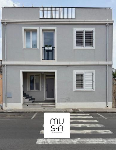 a sell sign in a parking lot in front of a house at MUSA DOMO Fàinas in Càbras