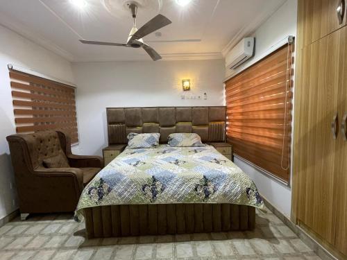 a bedroom with a bed and a chair at Paradise Creek Hotel in Tamale