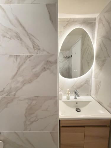 a bathroom with a sink and a mirror at Harbour No4 in Polis Chrysochous