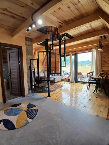 a living room with a table and a dining room at Chalet Anika in Kolašin