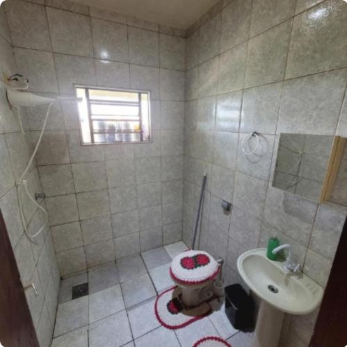 a small bathroom with a sink and a toilet at Pousada Welsh in Bueno Brandão