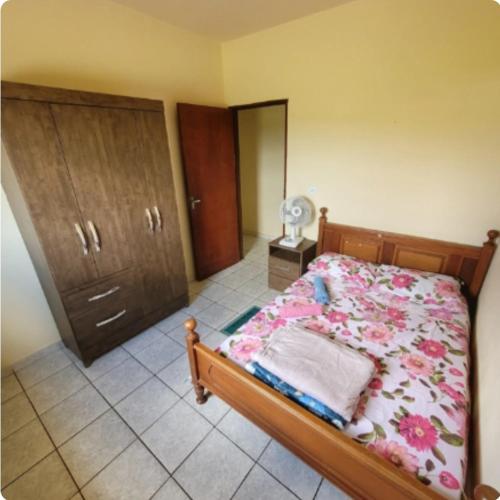 a bedroom with a bed and a dresser at Pousada Welsh in Bueno Brandão