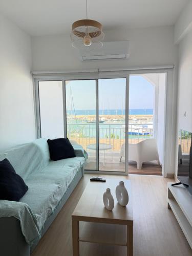 a living room with a couch and a view of the ocean at Harbour No4 in Polis Chrysochous