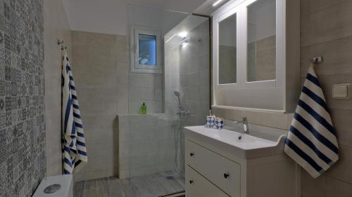 a bathroom with a sink and a shower at Villa Athena Ermioni in Ermioni