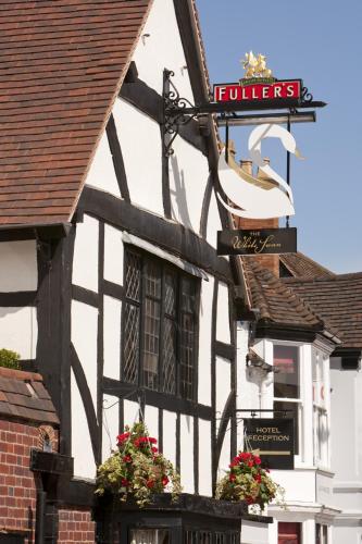 a black and white building with a sign on it at The White Swan Hotel in Stratford-upon-Avon