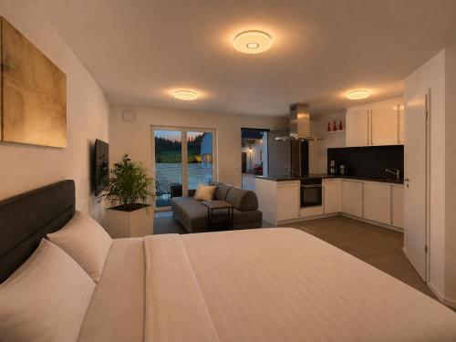 a bedroom with a bed and a living room at Villa Number 8 in Feldberg