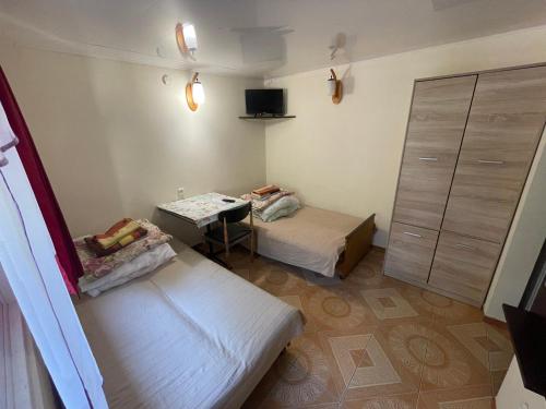 a small room with two beds and a table at Domki u Ani in Białka