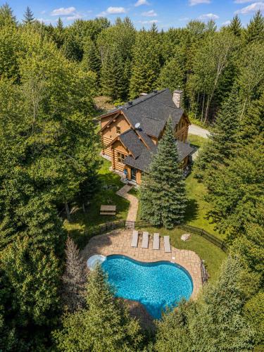 an aerial view of a house with a swimming pool at Blue Bear Spa sauna private pool lake access in Wentworth