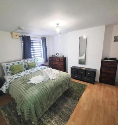 a bedroom with a bed with a white animal on it at Ground Floor Flat 1 Seven Cambrian square in Newtown