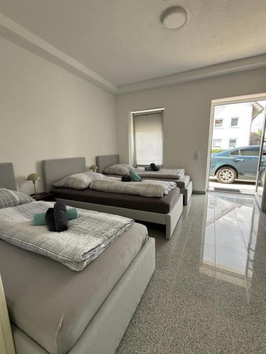 three beds in a room with a car outside a window at Team at Home Senden W2 in Senden