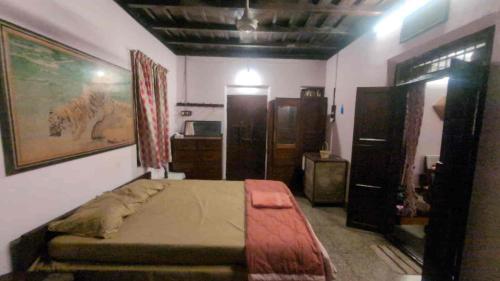 a bedroom with a bed and some wooden furniture at Le Stories Heritage Home in Kottayam