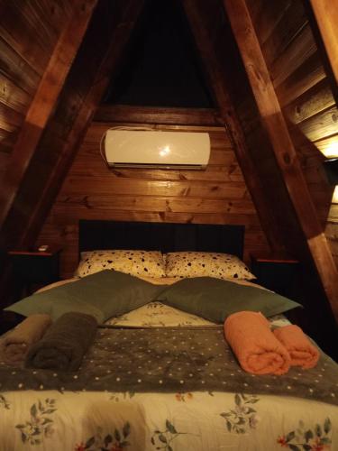 a bedroom with a bed in a attic at Chalé in Jaraguá do Sul