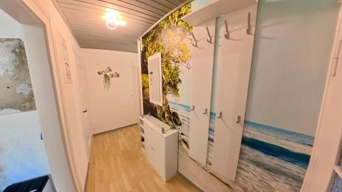 a hallway with a wall mural of the ocean at Ferienwohnung Glück auf in Gornsdorf