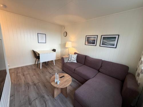 a living room with a couch and a table at Havnegata Apartments in Vadsø