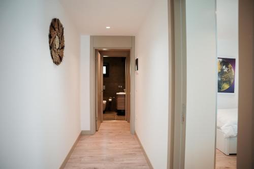 a hallway leading to a bedroom with white walls at Palladium Beach Resort- Luxury Leading Hotels, Private Beach Included in Dhërmi