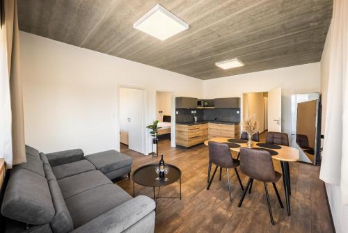 a living room with a couch and a table at Apartmány Panelka Costa Plana Lipno in Černá v Pošumaví