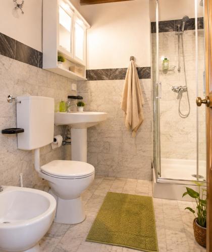 a bathroom with a toilet and a sink and a shower at Max Studios Florence in Florence