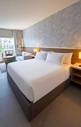 a large white bed in a hotel room at Wyndham Garden Durango in Durango
