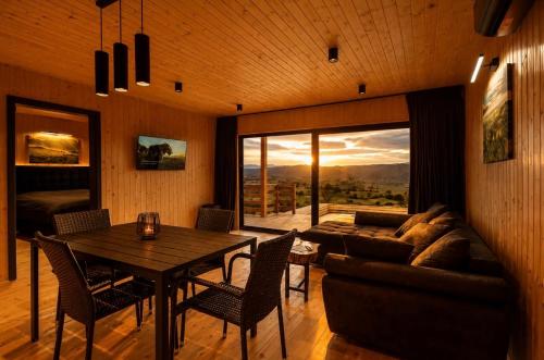 a living room with a couch and a table at Sunset Hill Chalet Sighișoara in Sighişoara
