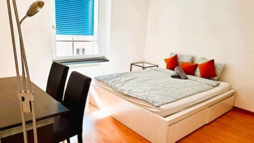 a bedroom with a bed and a desk and a window at 2 Room Center Zurich Flats with Balcony - HildaB in Zurich