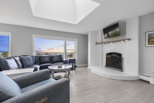 a living room with a couch and a fireplace at Gulls Nest in Gloucester