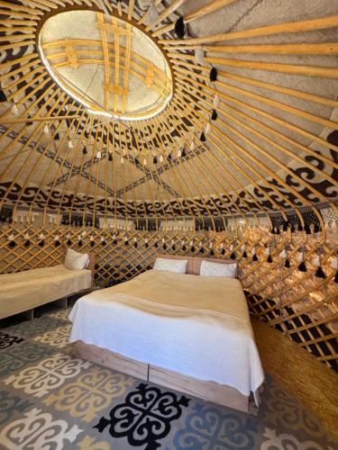 a bedroom with a bed and a large mirror at Yurt Camp by Fly Service in Song-Kul