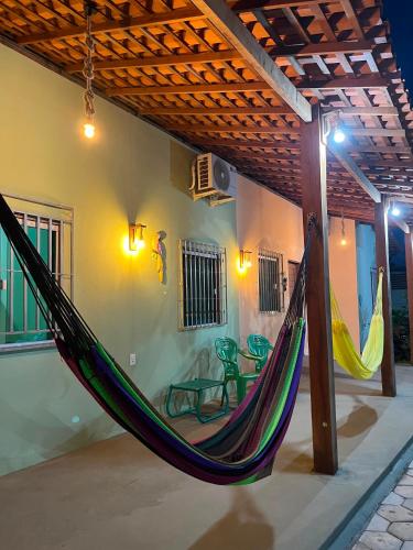 a patio with a hammock in a house at Vila da Andrea 02 in Barreirinhas