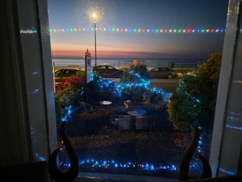 a view of a yard with christmas lights at St. Hilary Guest House in Llandudno