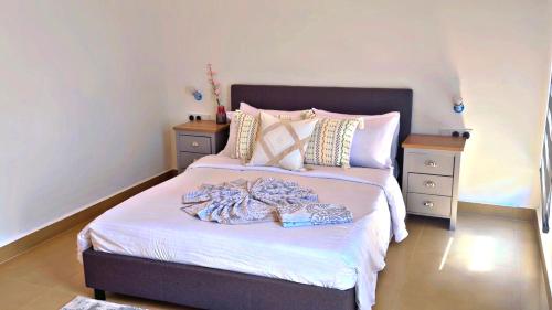 a bedroom with a bed with towels on it at Two Bedroom Moyoni Apartment in Mchamba Wima