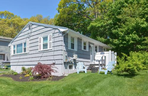 a tiny house with two chairs in a yard at Ryal Side Hideaway Cove in Beverly