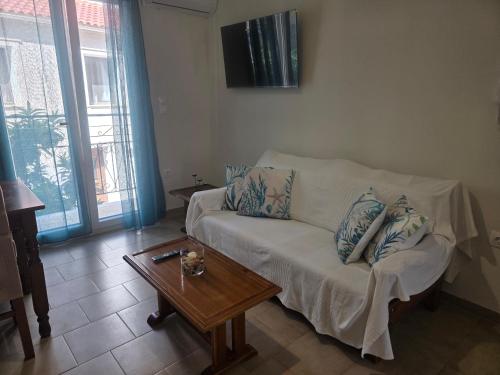 a living room with a couch and a coffee table at Diogenes Apartments in Samos