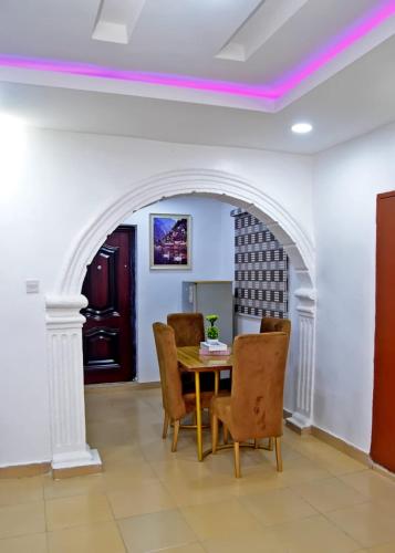 a dining room with an archway and a table and chairs at Hilltop Apartments in Mosan