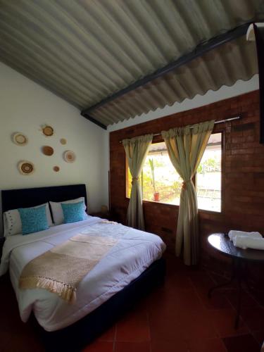 a bedroom with a large bed and a window at Alojamiento temático Rancho Texas in La Mesa