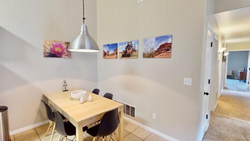 a dining room with a table and some pictures on the wall at Red Cliff Condos #3i in Moab