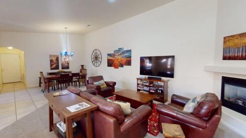 a living room with leather furniture and a fireplace at Leisure Space #327 in Moab